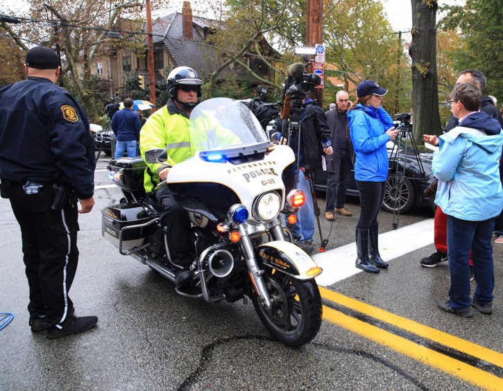 A police officer on motorcycle passes through a roadblock as he responds after a gunman opened fire at the Tree of Life synagogue in Pittsburgh, Pennsylvania, U.S., October 27, 2018.   REUTERS/John Altdorfer