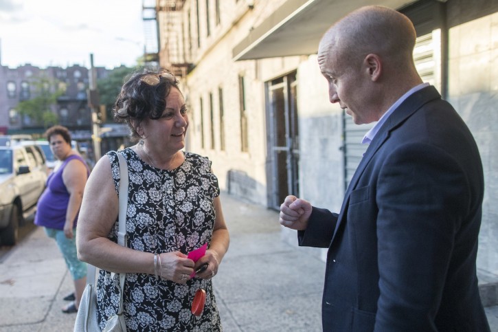 In this Wednesday, Oct. 3, 2018 photo, Democratic congressional candidate Max Rose, Annemarie Rossi while canvasing in the Bay Ridge neighborhood of the Brooklyn borough of New York.  (AP Photo/Mary Altaffer)