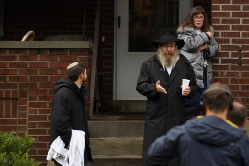   Residents talk to the media near the site of a mass shooting at the Tree of Life Synagogue in the Squirrel Hill neighborhood on October 27, 2018 in Pittsburgh, Pennsylvania.  (Photo by Jeff Swensen/Getty Images)
