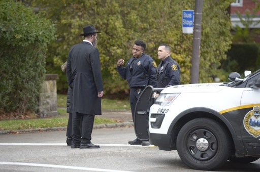 Police speak with members of the community after a shooting at the Tree of Life Synagogue at Squirrel Hill, Pennsylvania on October 27, 2018. (DUSTIN FRANZ/AFP/Getty Images)