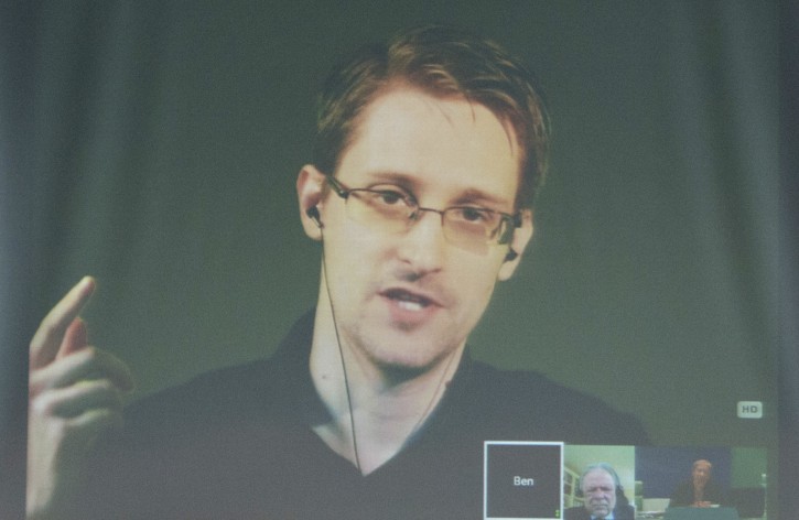 FILE - US Whistleblower Edward Snowden is seen on a screen as he speaks to journalists during a video news conference, in the Council of Europe building in Strasbourg, France, 23 June 2015. EPA