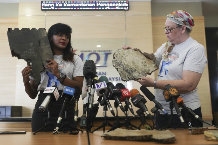 Grace Subathirai Nathan, (L) daughter of missing Malaysia Airlines flight MH370 passenger Anne Daisy and  also MH370 #SearchOn Campaign leader and Jacquita Gonzales (R) widow of missing MH370 in-flight supervisor, Patrick Francis Gomez, shows a part of the debris believed to belong to MH370 during press conference at ministry of transport headquarters in Putrajaya, Malaysia, 30 November 2018.  EPA