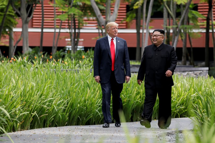 FILE PHOTO: U.S. President Donald Trump and North Korea's leader Kim Jong Un walk together before their working lunch during their summit at the Capella Hotel on the resort island of Sentosa, Singapore June 12, 2018. REUTERS/Jonathan Ernst/File Photo