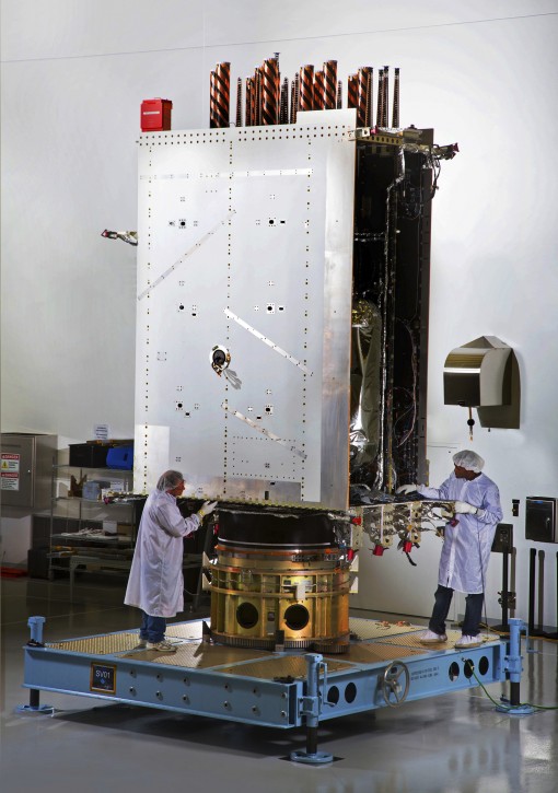 This April 9, 2015 photo provided by Lockheed Martin shows the first GPS III satellite being built in a clean room at Lockheed Martin's complex south of Denver. The satellite is scheduled to be launched from Cape Canaveral, Fla., on Tuesday, Dec. 18, 2018. (Pat Corkery/Lockheed Martin VIA AP)