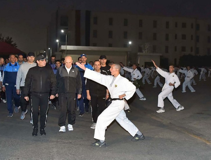 In this Dec. 16, 2018 photo released by the Egyptian Presidency, Egyptian President Abdel-Fattah el-Sissi inspects cadets during their morning exercises at the national Military Academy, in a suburb of Cairo, Egypt. AP