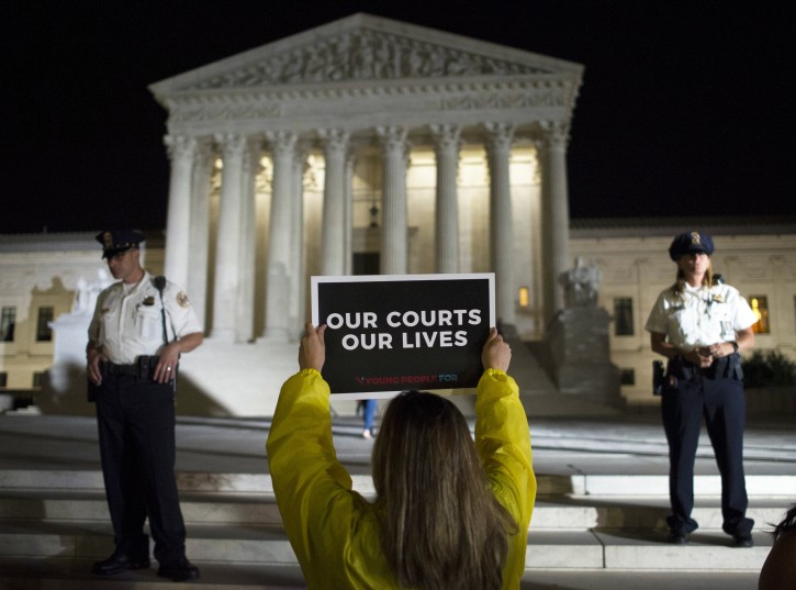 FILE - In this July 9, 2018, file photo a demonstrator protests in front of the Supreme Court in Washington. The Supreme Court term has steered clear of drama since the tumultuous confirmation of Justice Brett Kavanaugh. The next few weeks will test whether the calm can last. (AP Photo/Cliff Owen, File )