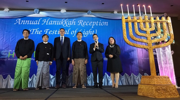 Sammy Samuels, second from right, sings at a Hanukkah event with Burmese leaders. Israel’s ambassador to Myanmar, Ronen Gilor, is third from left; between them is Phyo Min Thein, the chief minister of the Yangon region. (Charles Dunst)