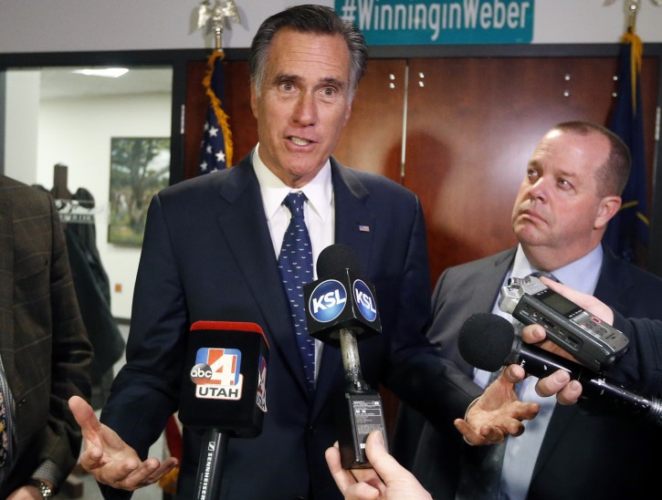 Utah Sen. Mitt Romney, left, speaks with reporters after visiting with local officials to discuss how the four-week partial government shutdown is impacting an area with several major federal employers, including the Internal Revenue Service, Friday Jan., 18, 2019, in Ogden, Utah. (AP Photo/Rick Bowmer)