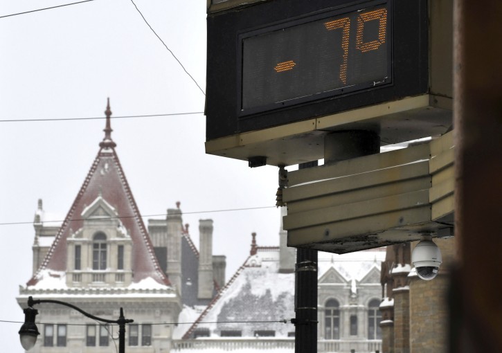A temperature of -7 degrees Fahrenheit was shown at the Bank of America Financial Center on Sate Street, against a backdrop of the New York State Capitol on Monday morning, Jan. 21, 2019, in Albany, N.Y. (Will Waldron/The Albany Times Union via AP)