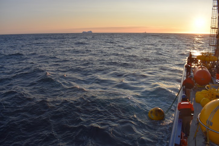 In this September 2018 photo provided by researcher Isabela Le Bras, mooring for measuring equipment is recovered just offshore of Greenland in the early morning with icebergs visible in the background. Scientists were studying the Atlantic Meridional Overturning Circulation (AMOC), a circulation of warm and cold waters that stretches from around Greenland south to beyond the tip of Africa and into the Indian Ocean. (Isabela Le Bras via AP)