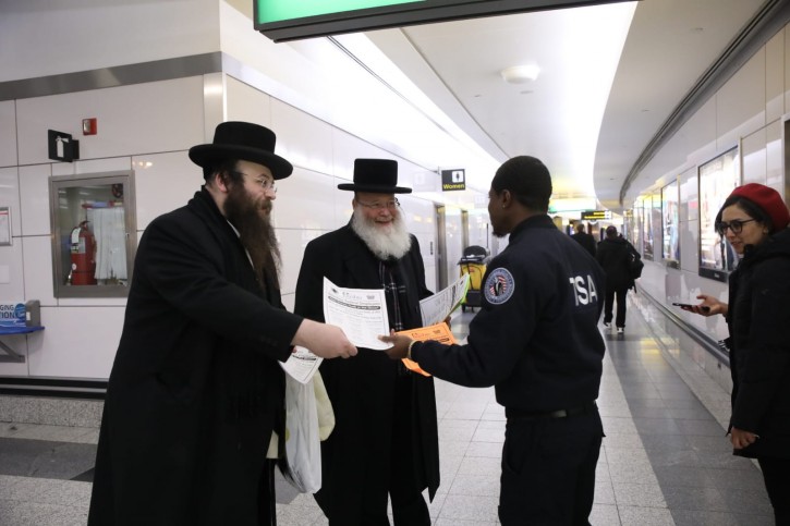Brooklyn resident Alex Rappaport Founder and CEO of the Jewish soup Kitchen Masbia, handing out flyers at LaGuardia Airport, informing Federal workers who's pay check have been affected by the U.S. Government shutdown, about free groceryâs and food for their family by his organization. 