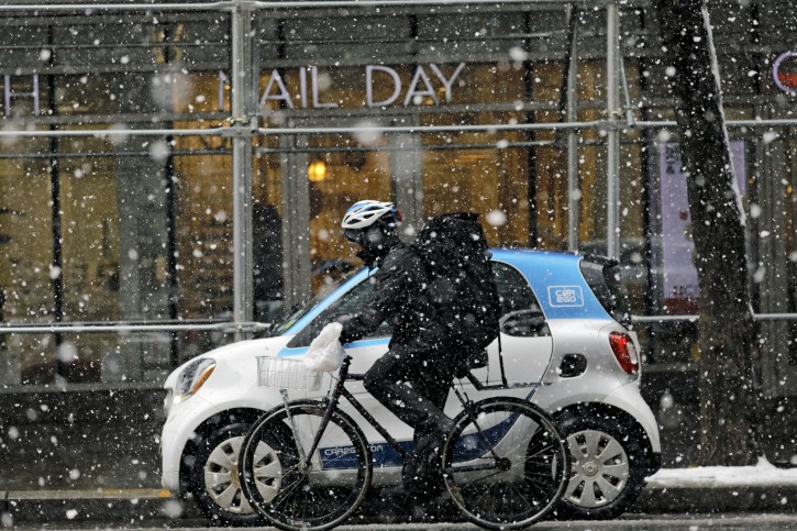 Late Season Snowstorm Hits US Northeast FILE - A man rides a bicycle in the snow during a late season snowstorm in New York, New York, USA, 21 March 2018. EPA