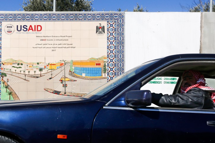 A car drives near near a sign of the U.S. Agency for International Development (USAID) project in Hebron in the West Bank on February 5, 2019. Photo by Wisam Hashlamoun/Flash90