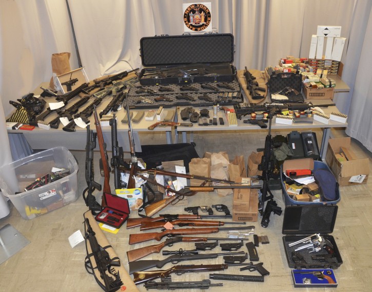 In this March 1, 2019 photo provided by the New York State Police in Middletown, N.Y., a cache of illegally manufactured handguns and assault rifles confiscated from New York City Department of Environmental Protection Police Sergeant Gregg Marinelli are shown. Marinelli, who was arrested at his Plattekill, N.Y. home on Thursday, Feb. 28, 2019, faces illegal arms manufacturing and sales charges well as a charge of Hindering Prosecution. (New York State Police via AP)