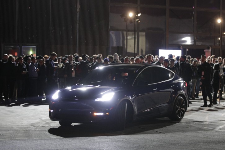 People wait outside Tesla's design studio for a test drive of the Model Y, Thursday, March 14, 2019, in Hawthorne, Calif. The Model Y may be Tesla's most important product yet as it attempts to expand into the mainstream and generate enough cash to repay massive debts that threaten to topple the Palo Alto, Calif., company. (AP Photo/Jae C. Hong)