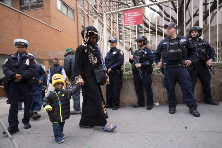 People leave the Islamic Cultural Center of New York under increased police security following the shooting in New Zealand, Friday, March 15, 2019, in New York. (AP Photo/Mark Lennihan)
