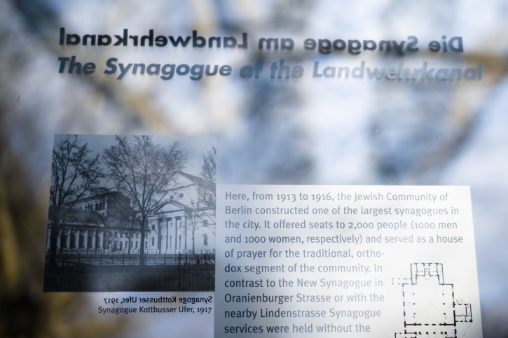 In this Wednesday, March 20, 2019, a remembrance plague displays information and a photo of the former 'Fraenkelufer' synagogue, in Berlin, Wednesday, March 20, 2019. The synagogue was able to receive about 2000 prayers before it was destroyed by the Nazis. In the German capital, efforts are underway to rebuild the synagogue.  (AP Photo/Markus Schreiber)