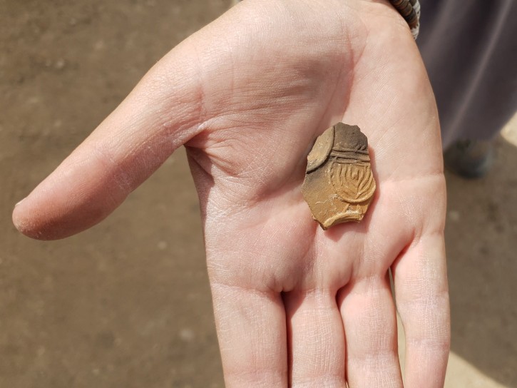2,000-year-old oil lamp sherd decorated with a nine-branched menorah discovered at an excavation near Tel Beer Sheva. (Anat Rasiuk, Israel Antiquities Authority)