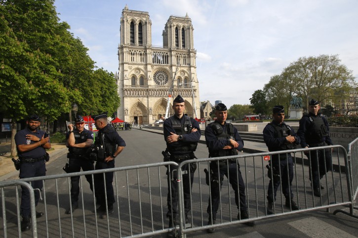 Police officer stand behind the security barriers in front of Notre Dame cathedral Thursday, April 18, 2019 in Paris.