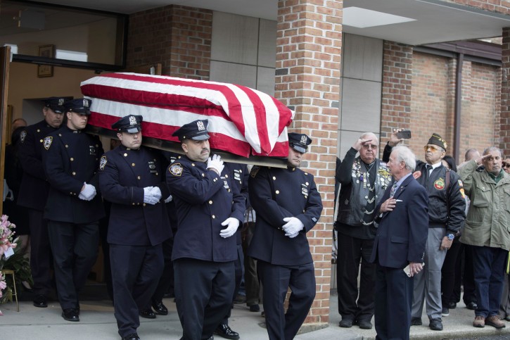 The casket of Marine Private First Class Robert Graham is carried out of St.Elizabeth Ann Seton Church by members of the New York City Police Department on Friday, April 26, 2019 in Shrub Oak, NY. Graham, who died at 97 has no living family members but his friend Beth Regan arranged for hundreds to attend his funeral. (AP Photo/Allyse Pulliam)