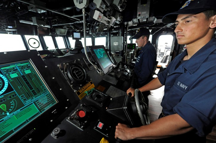 Seaman Art Casillas, a helmsman aboard the Arleigh Burke-class guided-missile destroyer USS Dewey (DDG 105), steers the ship during a transit of the Spratly Islands, South China Sea September 16, 2011. Petty Officer 3rd Class Joshua Keim/Handout via REUTERS