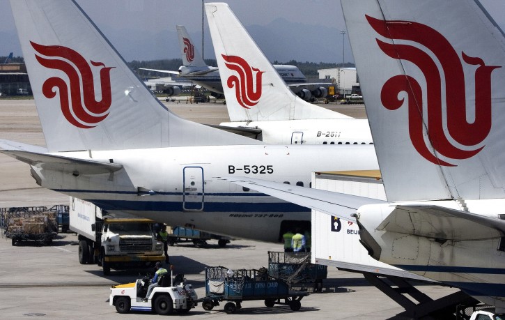 In this Aug. 29, 2007 file photo, Air China passenger airliners park at the Beijing International Airport in Beijing, China. (AP Photo/Greg Baker, File)