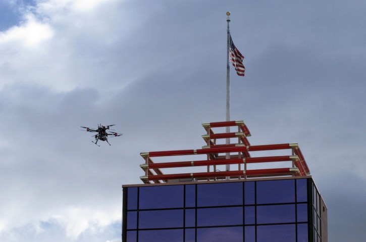 A drone flys over downtown Reno before landing on the Cal-Neva casino parking garage on Tuesday, May 21, 2019 as part of a NASA simulation to test emerging technology that someday will be used to manage travel of hundreds of thousands of commercial, unmanned aerial vehicles (UAVs) delivering packages. It marked the first time such tests have been conducted in an urban setting. (AP Photo/Scott Sonner)