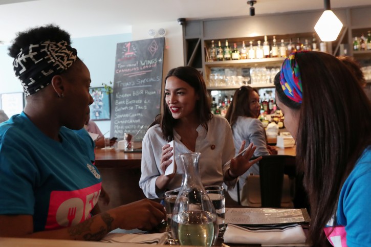 Rep. Alexandria Ocasio-Cortez (D-NY) speaks with people after taking an order in support of One Fair Wage, a policy that would allow tipped workers to receive full minimum wage plus their tips in New York, at The Queensboro restaurant in the Queens borough of New York, U.S., May 31, 2019. REUTERS/Shannon Stapleton
