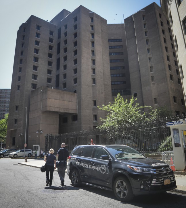 New York City medical examiner personnel leave their vehicle and walk to the Manhattan Correctional Center where financier Jeffrey Epstein died by suicide while awaiting trial on sex-trafficking charges, Saturday Aug. 10, 2019, in New York. AP